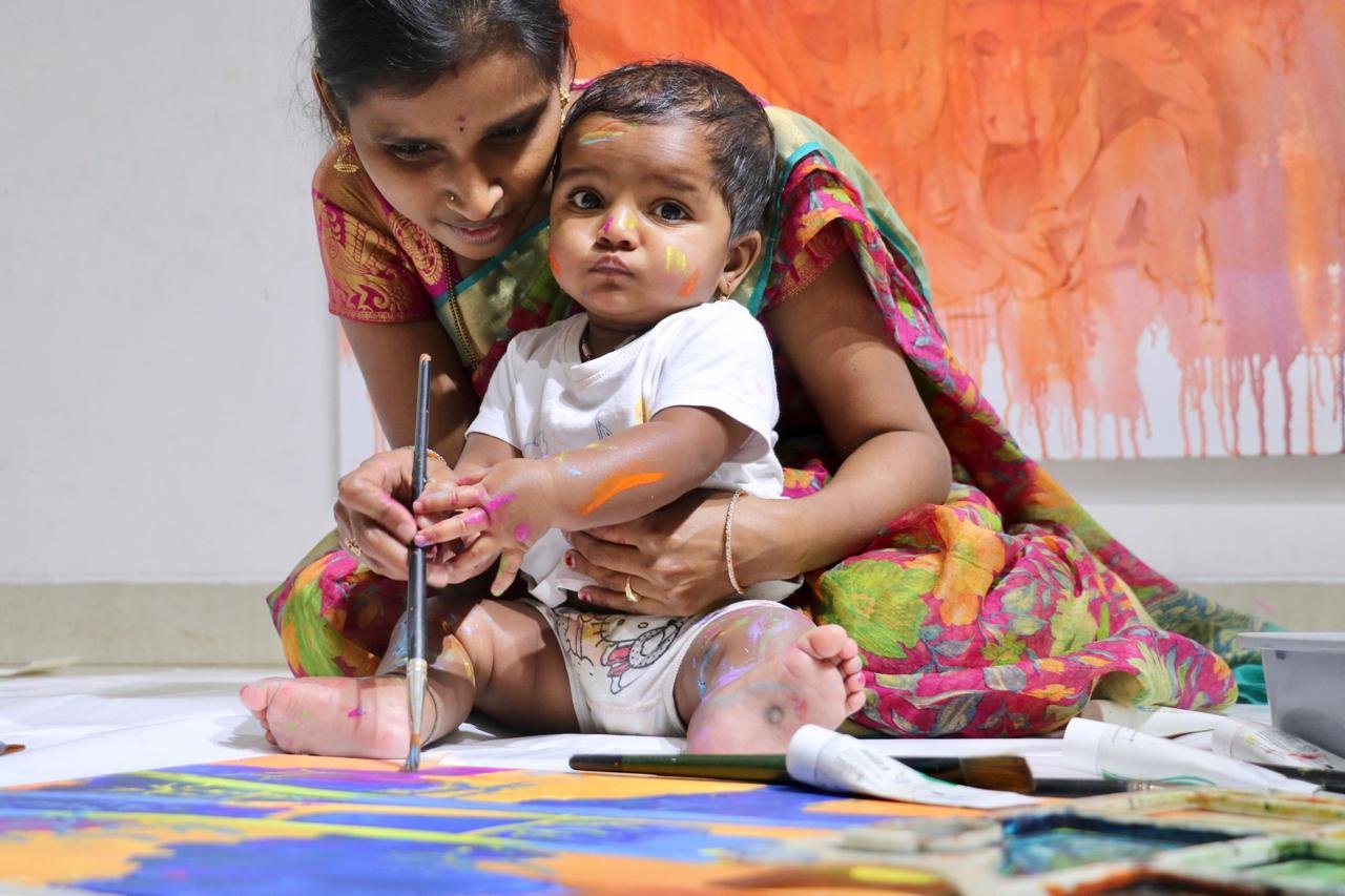 Toddler finger painting with bright colors
